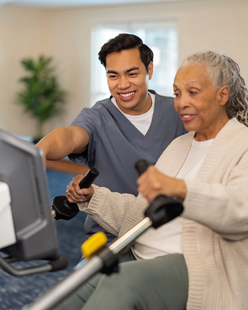 a nurse helps a patient with physical rehabilitation